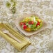 A Bambu square bamboo plate with a salad and a fork on a table.