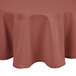 A mauve Intedge round tablecloth on a table.