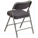 A Flash Furniture gray fabric metal folding chair with a cushion.