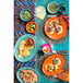 A table set with a Tuxton Papaya Oval China platter filled with food, a bowl of soup, and a cup of beer.
