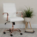 A white office chair with a rose gold frame.