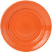 An orange Tuxton Concentrix China plate with a spiral pattern.