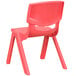a red plastic chair with legs