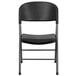 A black Flash Furniture plastic folding chair with a charcoal metal frame and legs.