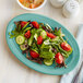 a plate of salad with tomatoes