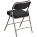 A black folding chair with black pin-dot fabric and metal frame.