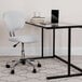 A white desk with a Flash Furniture white mesh office chair with a black base.