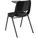 A black plastic Flash Furniture chair with a right handed tablet arm on a table.