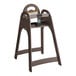 A brown plastic high chair with a safety strap, designed for children.