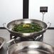 An American Metalcraft stainless steel serving pan with asparagus and a lemon wedge.