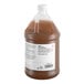 A one-gallon plastic jug of concentrated pine cleaner with a white label and brown liquid inside.
