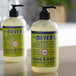 A couple of Mrs. Meyer's Lemon Verbena hand soap bottles with pumps.