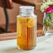 An Anchor Hocking Bistro pitcher with iced tea and lemon slices in it.
