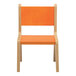 A Whitney Brothers wooden children's chair with a hot pumpkin seat and back.