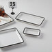 A white rectangular American Metalcraft melamine tray with black trim on the rim.