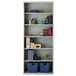 A light gray Hirsh welded steel bookcase with books and objects on it.