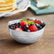 An American Metalcraft stainless steel bowl filled with fruit.