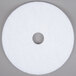 A white circular pad with a hole in the middle.