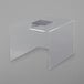 A clear acrylic table with a clear plastic box on top with silver edges.