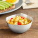 An American Metalcraft stainless steel snack bowl filled with fruit salad on a table.