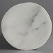 A white marble plate with black veins.