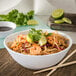 A Carlisle marble melamine bowl filled with noodles, shrimp, and lime wedges.