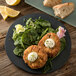 A Carlisle slate melamine plate with fried chicken, salad, and a lemon wedge.