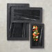 A rectangular black marble and slate two-tone serving platter.