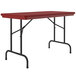 A red rectangular Correll folding table with black legs.