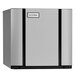 An Ice-O-Matic air cooled ice machine with a silver and black rectangular shape and a black door.
