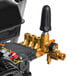 A close up of a Simpson gas powered pressure washer with a red cap.