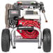 A Simpson gas powered pressure washer with a hose attached.