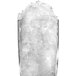 A glass filled with Ice-O-Matic flake ice on a white background.