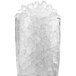 A clear glass container full of Ice-O-Matic pearl nugget ice on a white background.