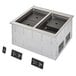 A Vollrath two well modular induction drop-in hot food well on a counter in a school kitchen.