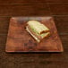 a sandwich on a square plate