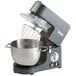 A Hamilton Beach countertop mixer with a bowl and whisk attachment.