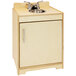 A Whitney Brothers natural wood play sink cabinet with a door.