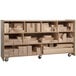 A Whitney Brothers wooden storage cart with shelves holding blocks of different shapes and sizes.