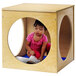 A child playing on a blue Whitney Brothers floor mat in a wooden play cube.