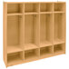 A Whitney Brothers wooden four section coat locker with shelves and doors.