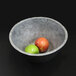 An Elite Global Solutions Basalt melamine serving bowl with two apples in it.