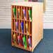 A Whitney Brothers wooden cabinet with colorful folders.