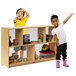 A boy and girl standing next to a Whitney Brothers preschool storage cabinet with acrylic backing.