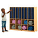 A child pointing to a blue Whitney Brothers rest mat storage cabinet.