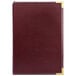 A red leather H. Risch, Inc. Seville menu cover with gold corners.