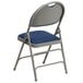 A navy blue metal folding chair with a padded blue seat and a backrest.