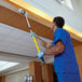 a man in blue scrubs holding a broom