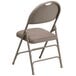 A Flash Furniture beige metal folding chair with a padded seat.