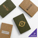 A set of four customizable Water Street Wicker menu covers in green and brown, each featuring different restaurant logos.
